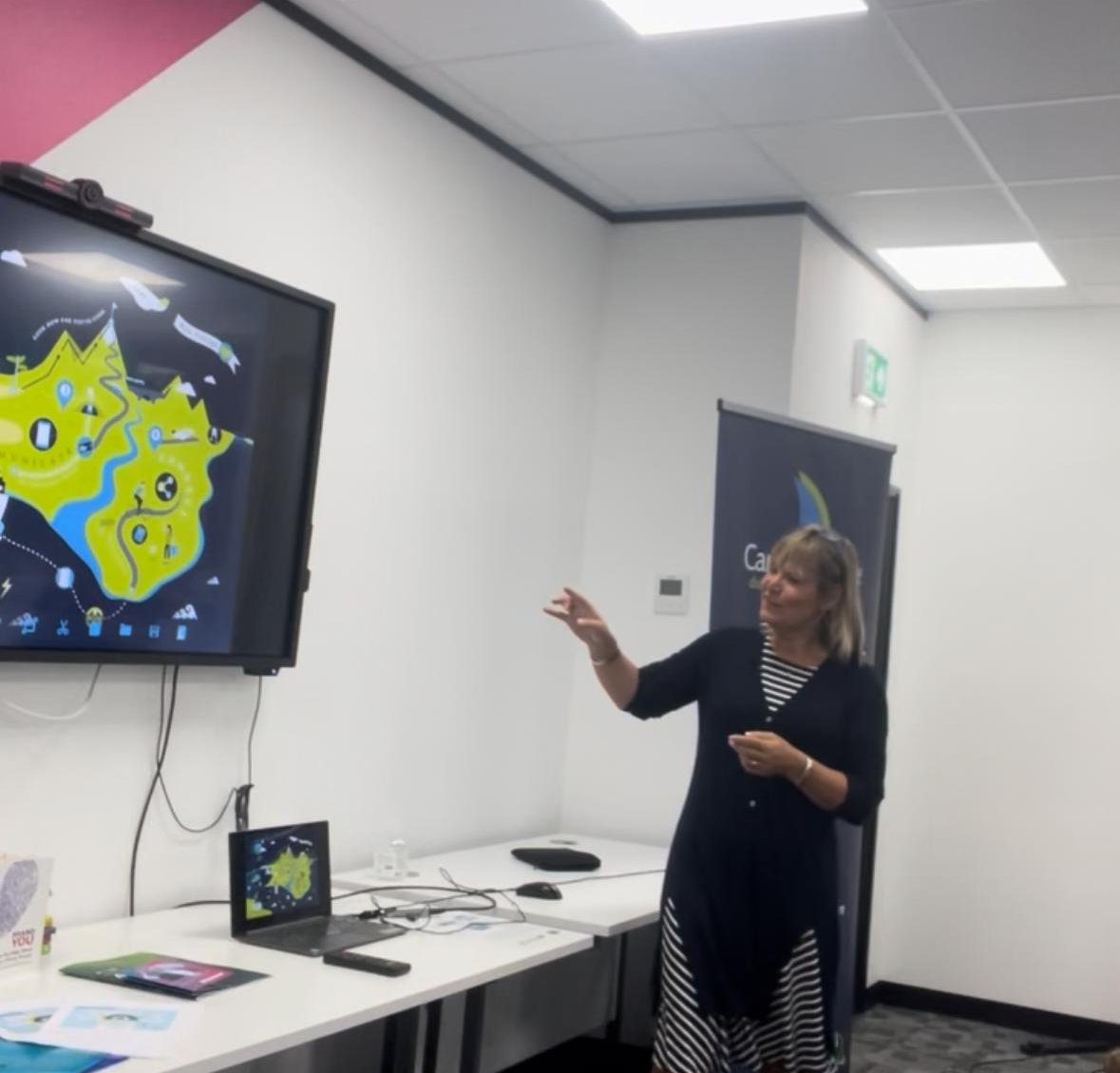 Sarah Taylor Phillips presenting to a Career Voyage workshop, gesturing towards a screen.